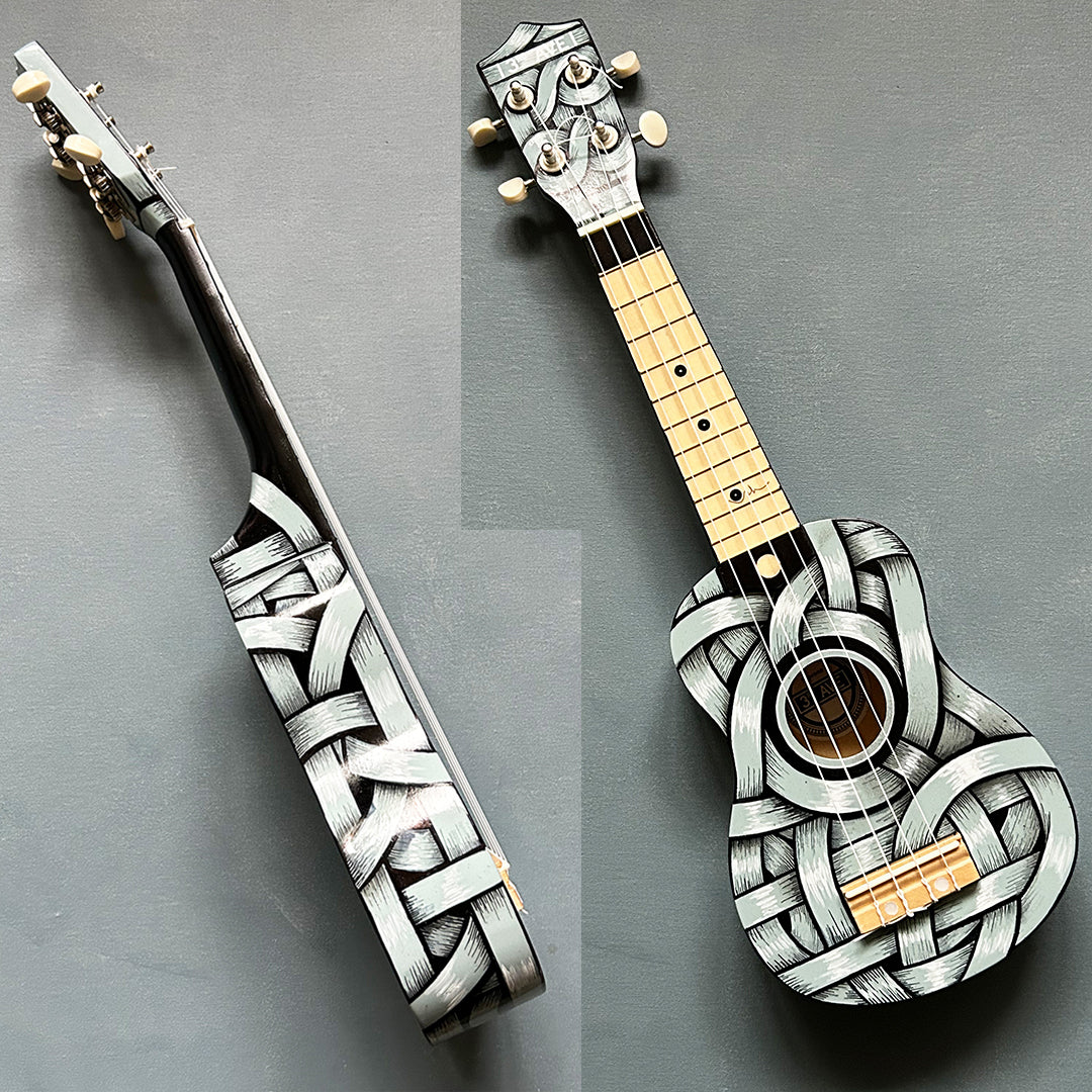 An Otto Schade AKA Osch unique artwork, a black and white ribboned ukelele